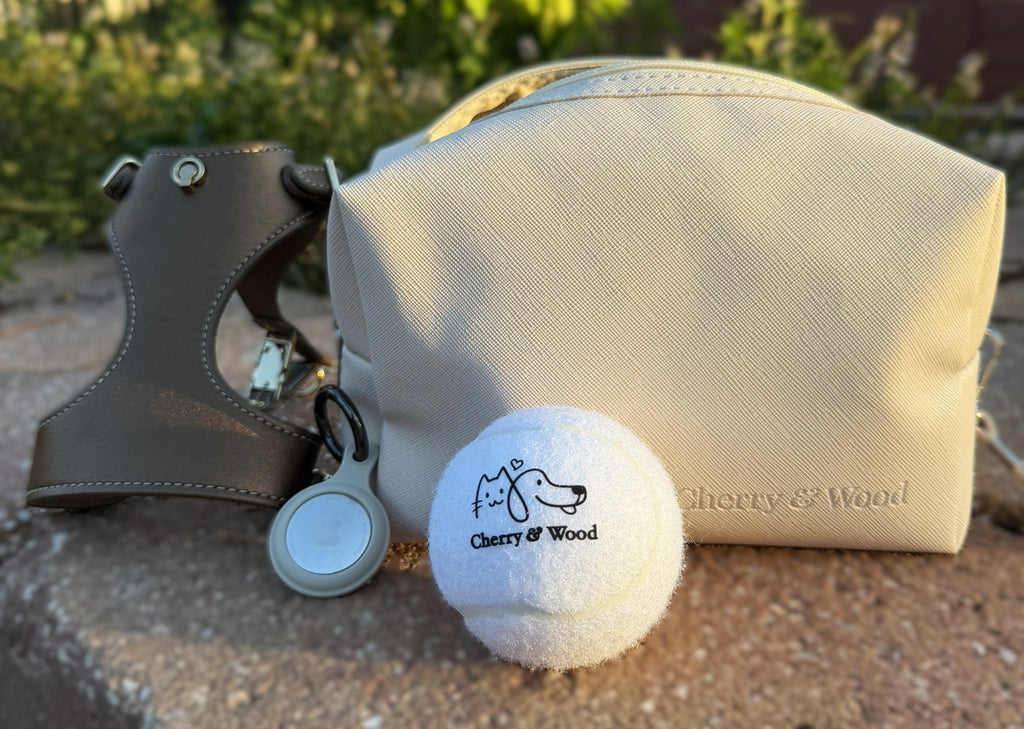 Tennis ball styled with a vanity bag, AirTag holder and bronze harness