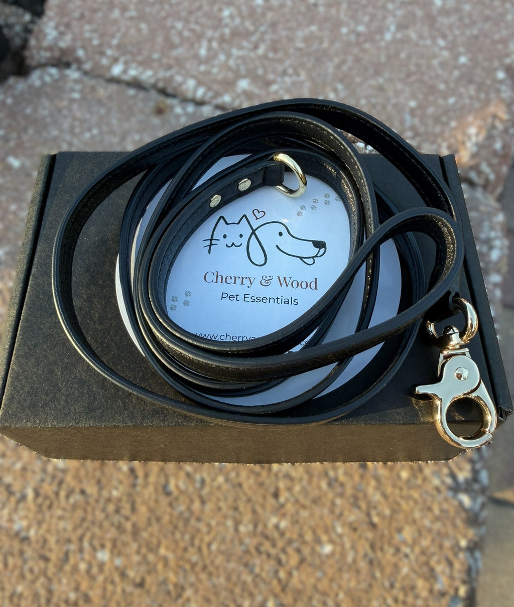 Black handmade leather leash coiled, top view